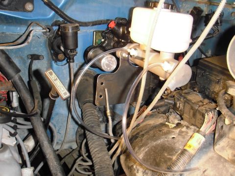 1995 Ford Bronco - Close-up of brake master cylinder and engine oil dipstick.
