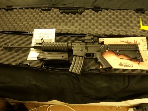 2000 Mercury Grand Marquis - An AR-15 rifle is displayed with its operation manual and extra magazines inside a protective case.