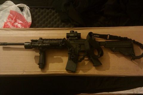 2000 Mercury Grand Marquis - AR-15 style rifle with optic and sling is shown on a flat surface.