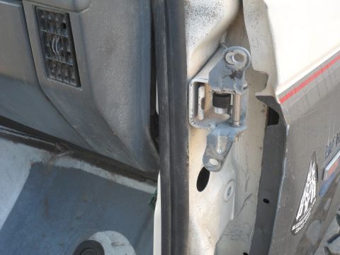 1991 Ford Bronco - This photo shows a close-up view of a vehicle's door hinge and an air vent on the interior panel.