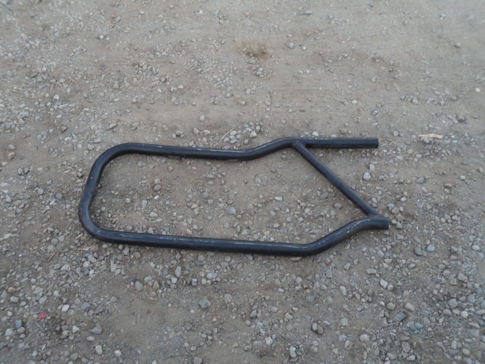Black metal door bar on gravel