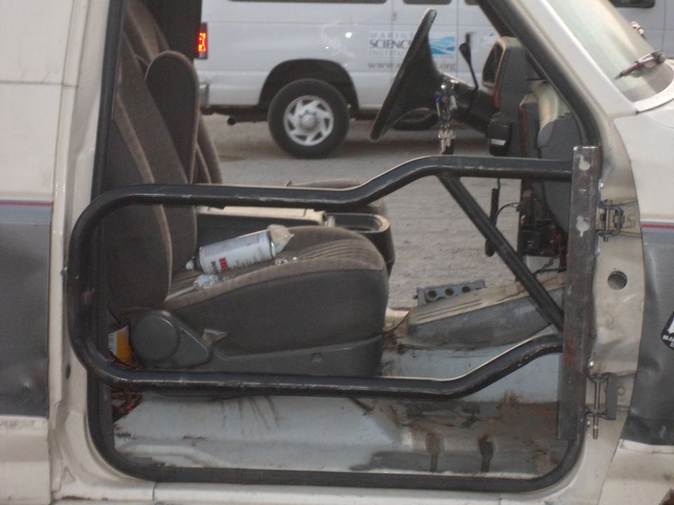 1991 Ford Bronco interior showing seats, roll cage, and dashboard