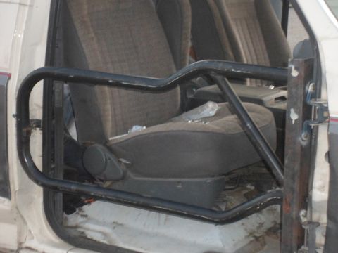 1991 Ford Bronco - Interior view of a 1991 Ford Bronco, showing the roll cage and seats.