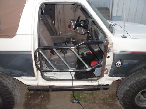 1991 Ford Bronco - Custom roll cage installed in the driver's side door frame of a 1991 Ford Bronco.