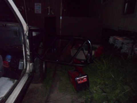 1991 Ford Bronco - Roll cage and generator positioned next to an open vehicle door.