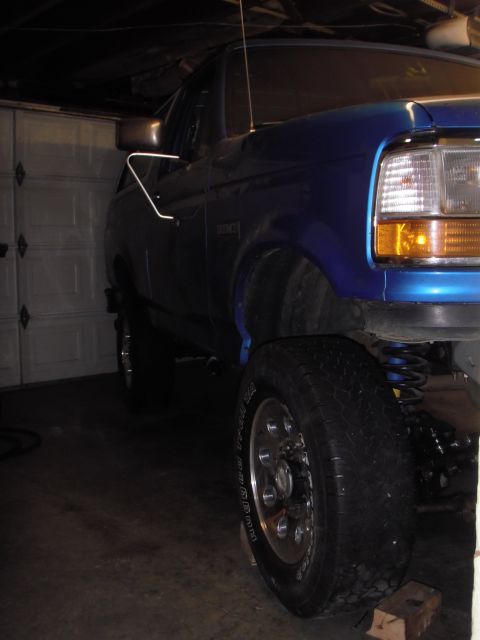 1995 Ford Bronco - Front quarter view of a blue 1995 Ford Bronco inside a garage.