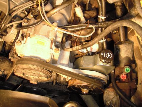 1995 Ford Bronco - Close-up view of an engine compartment, showing various mechanical components and hoses.