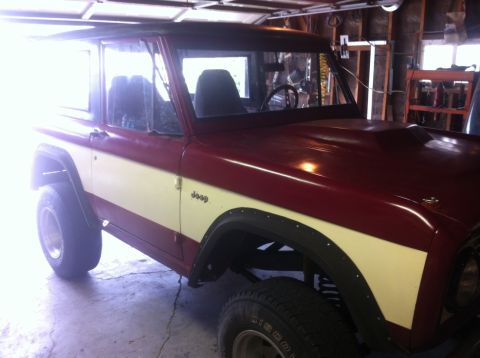 1989 Ford Bronco - This Jeep features a two-tone paint scheme and a prominent hood scoop.
