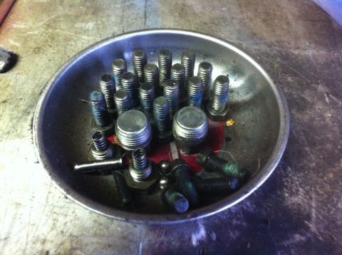 1989 Ford Bronco - A magnetic parts tray holds various bolts and threaded caps, likely for a mechanical project.