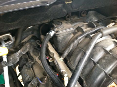 2010 Dodge 1500 - Close-up view of engine bay components, including fuel lines and intake manifold.