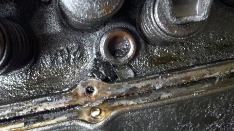 1978 Ford Bronco - This is a close-up view of an engine's cylinder head, showing oil and gasket material.