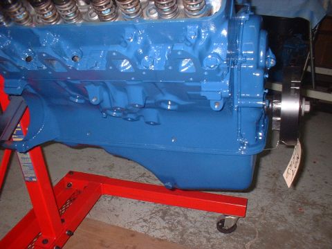 1969 Mercury Cyclone - A blue V8 engine block is mounted on a red engine stand, ready for assembly or inspection.