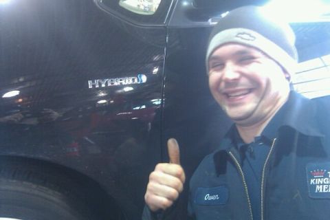 2000 Mercury Grand Marquis - Man gives thumbs up next to a car with a HYBRID badge.