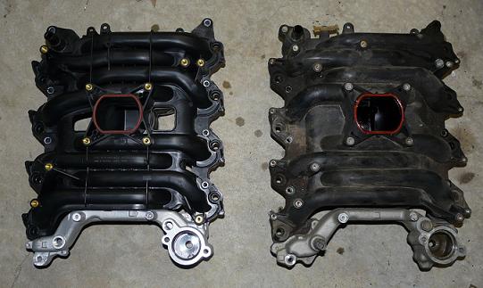 Two black plastic intake manifolds side-by-side on a concrete surface