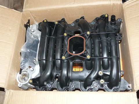 1999 Ford Crown Victoria - A new intake manifold is shown inside its shipping box, ready for installation.