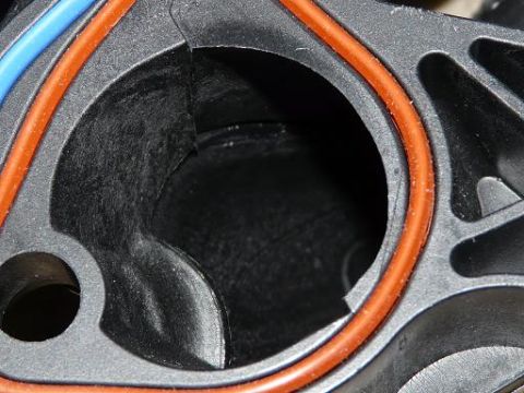 1999 Ford Crown Victoria - This is a close-up view of a vehicle's intake manifold part, showing internal passages and seals.