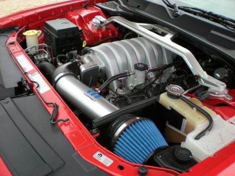 2010 Dodge Challenger - Engine bay view of a red Dodge Challenger with aftermarket Mopar intake and blue cone filter.