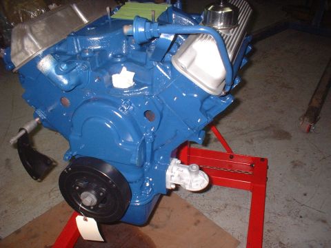 1969 Mercury Cyclone - A blue engine block with chrome valve covers is mounted on a red engine stand.