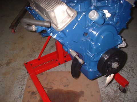 1969 Mercury Cyclone - A blue engine, likely a Ford FE series, is mounted on a red engine stand, ready for installation or work.
