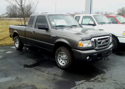 2011 Ford Ranger - A dark gray Ford Ranger pickup truck is parked outside, with other vehicles visible in the background.