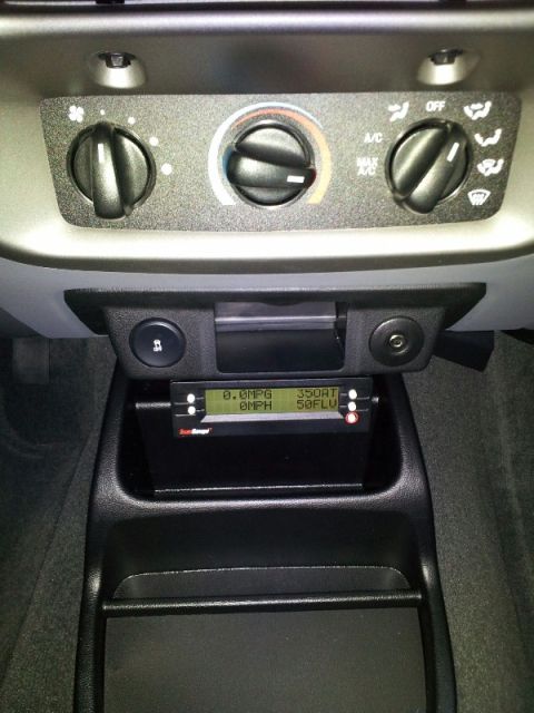 2011 Ford Ranger - The interior of a vehicle shows climate controls and a digital gauge displaying fuel economy and speed data.