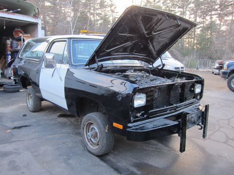 1987 Dodge 1500 - This two-tone SUV is parked outside with its hood up, revealing the engine compartment.
