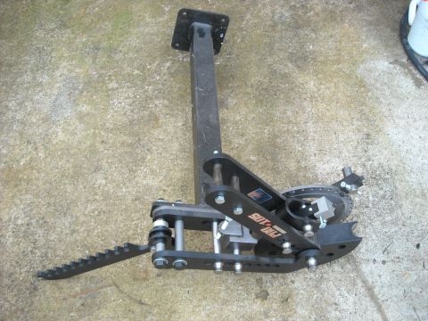 1979 Ford F-150 - A black metal tool with a serrated step and a circular geared mechanism is shown on a concrete surface.