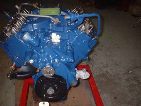 1969 Mercury Cyclone - A freshly painted blue V8 engine sits on a red engine stand, ready for installation.