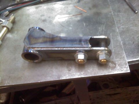 1996 Ford Bronco - A custom-welded suspension component sits on a workbench, ready for installation.