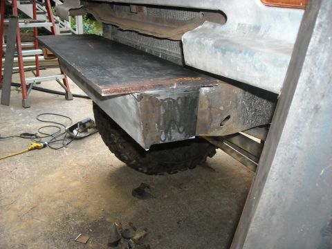 1979 Ford F-150 - A custom metal step is being fabricated and attached to the frame of a vehicle.