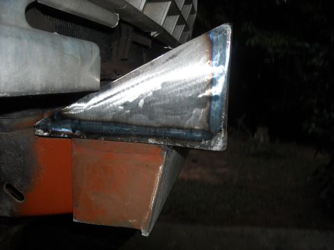 1979 Ford F-150 - A custom-fabricated metal piece is welded onto a vehicle's bumper structure.