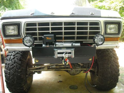 1979 Ford F-150 - The front of a 1979 Ford F-150 pickup truck is shown with a winch and auxiliary lights.
