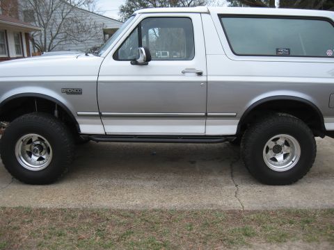 1994 Ford Bronco - The side profile of a 1994 Ford Bronco shows its two-tone paint scheme and off-road tires.