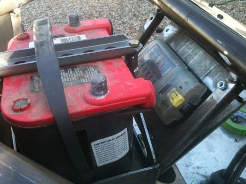 1966 Ford Bronco - Close-up of a vehicle battery and its associated fuse box, likely part of a custom build.