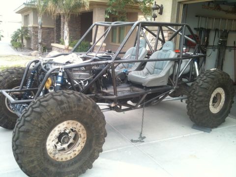1966 Ford Bronco - This custom-built buggy features a prominent roll cage and large tires, suggesting it's designed for off-road use.