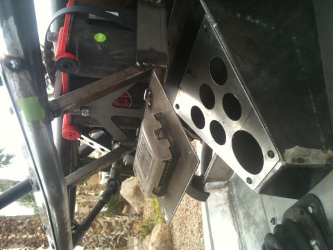 1966 Ford Bronco - Close-up view of custom vehicle chassis components, including fire extinguisher mounts and a control box.