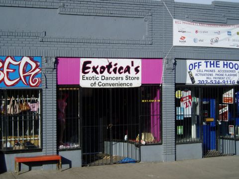 2009 Kenworth T800 - A storefront features multiple businesses, including 'Exotica's Exotic Dancers Store of Convenience' and 'Off The Hook' cell phone accessor…