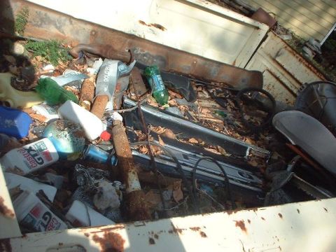1993 Ford Bronco - Debris fills the bed of a pickup truck, obscuring any potential vehicle details.