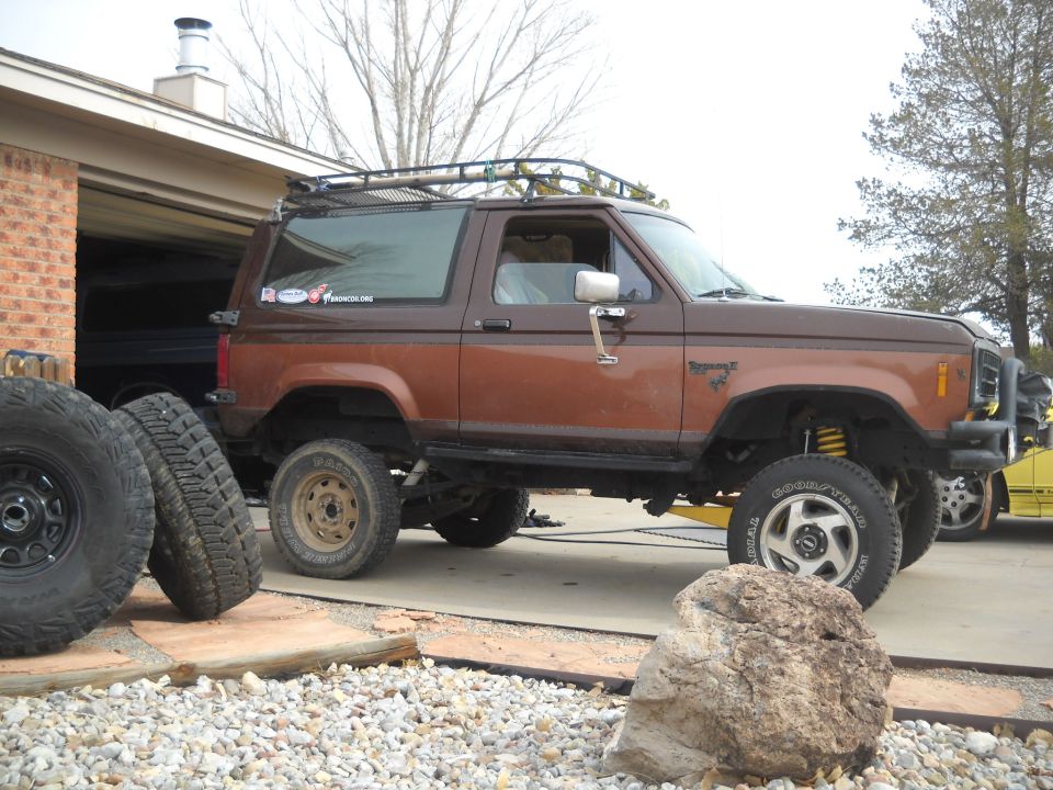 Brown 2-door SUV with roof rack and off-road tires