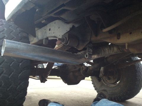 1995 Ford Bronco - Close-up view of the undercarriage and exhaust system of a vehicle, with visible suspension and drivetrain parts.