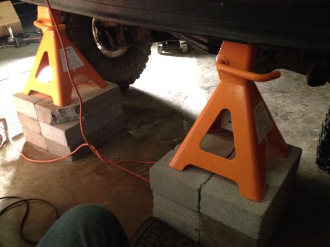 1995 Ford Bronco - Vehicle frame is raised on jack stands for maintenance.