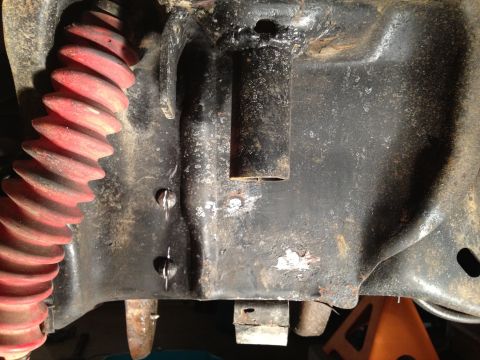 1995 Ford Bronco - A close-up view of a vehicle's frame and suspension components, showing rust and wear.