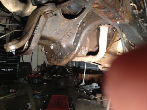 1995 Ford Bronco - Undercarriage view shows significant rust on suspension components and frame, indicating potential repair needs.