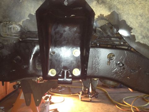 1995 Ford Bronco - Underbody view of a vehicle's frame and suspension components, likely undergoing maintenance or upgrades.