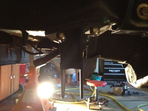 1995 Ford Bronco - Close-up view of a vehicle's undercarriage, focusing on suspension parts and hardware.