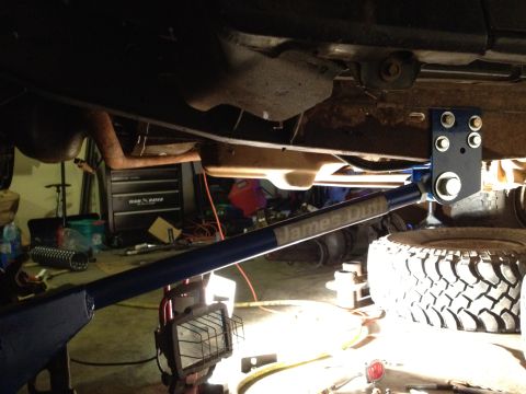 1995 Ford Bronco - The underside of a vehicle is shown, with a jack supporting it and a tire visible. The registry claims it is a 1995 Ford Bronco, but this i…