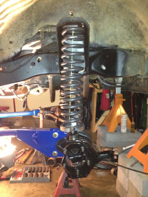 1995 Ford Bronco - The vehicle's suspension system is shown in detail, with a focus on the coil spring and axle.