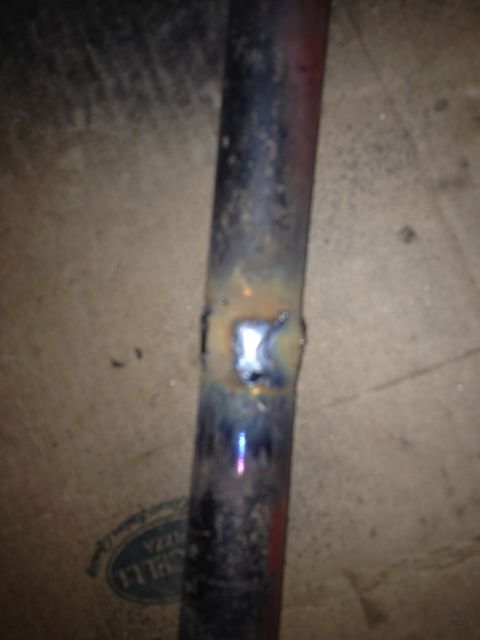 1995 Ford Bronco - A metal pipe exhibits a fresh weld, indicating repair or modification.