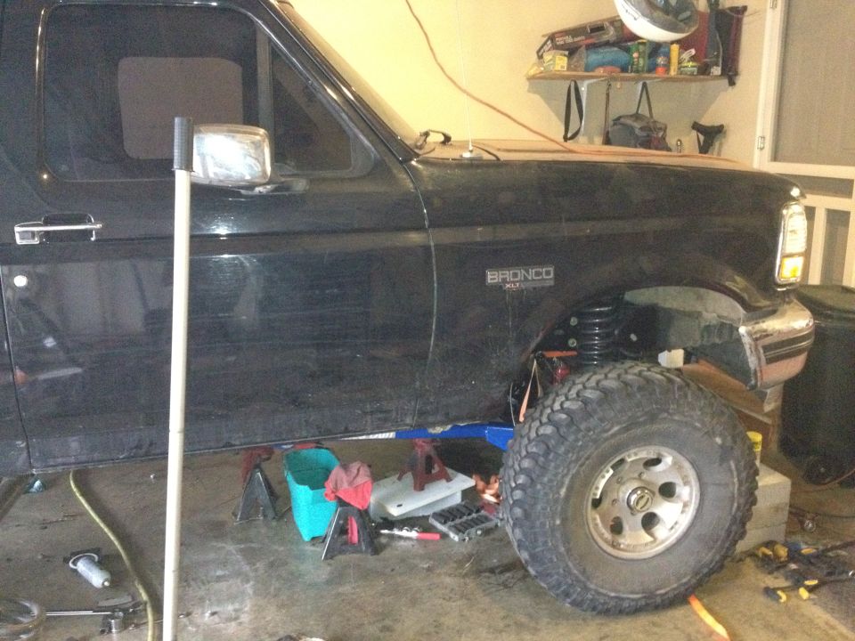 Black Ford Bronco side view, showing front tire and suspension