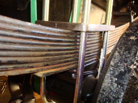 1995 Ford Bronco - The photo shows a close-up view of a vehicle's suspension system, focusing on the leaf spring and axle components.